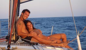 A beautifull couple relaxing on the deck of Barca's sailing boat in Santorini