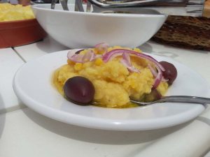 Tasty greek potato salad with onions, olives and olive oil